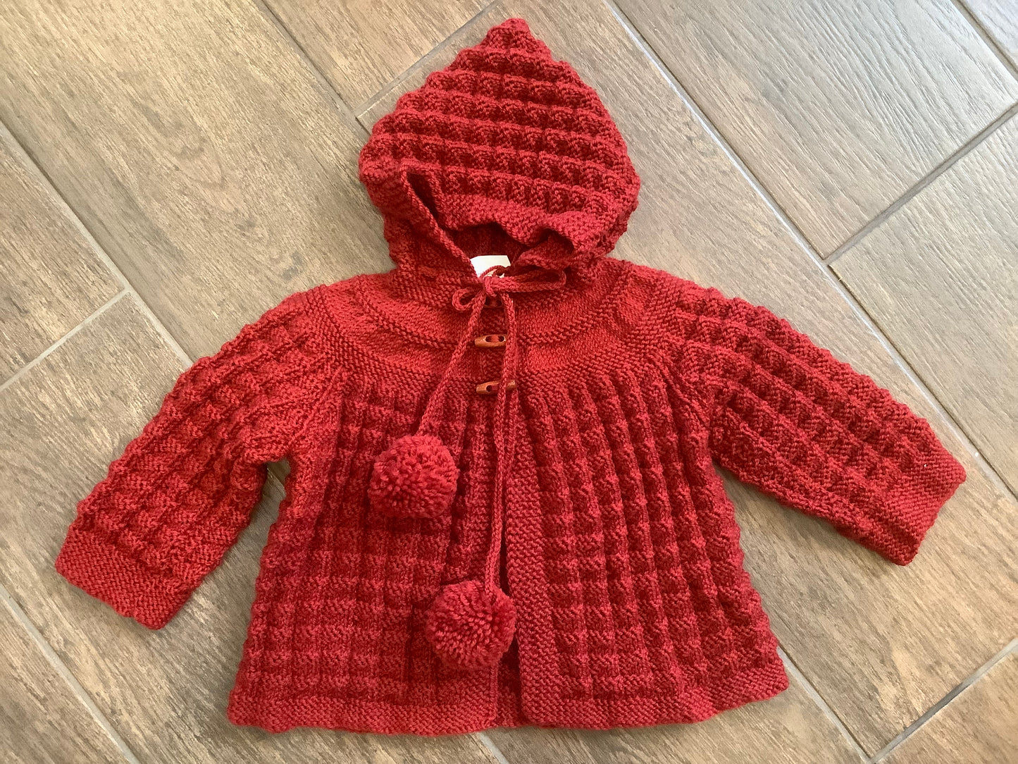 Hand Knitted Hooded Jacket with Pom Poms